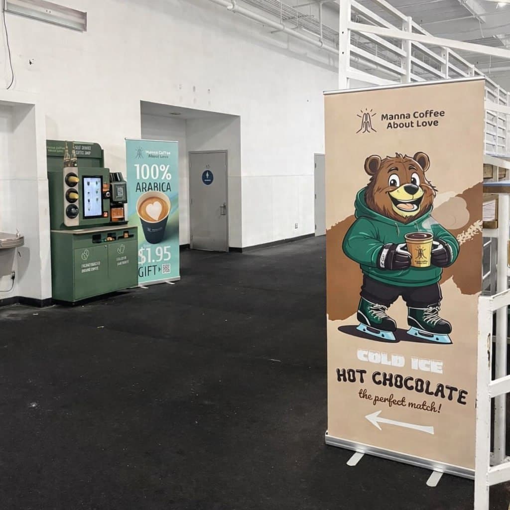 Coffee kiosk and promotional banner at an ice rink venue